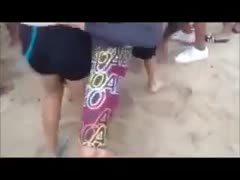On a beach, an ecstatic, lustful white wife presses her a-hole on a man's crotch.